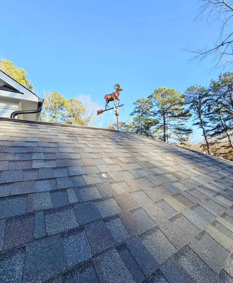 A well-maintained roof on a residential home in the Raleigh-Durham area, showing clean gutters and intact shingles