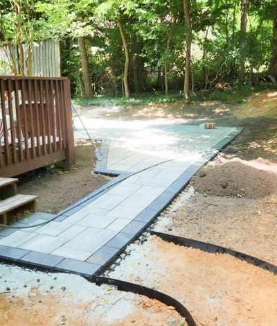 A completed grading project showing a levelled and well-drained area around a home, prepared for landscaping or construction.