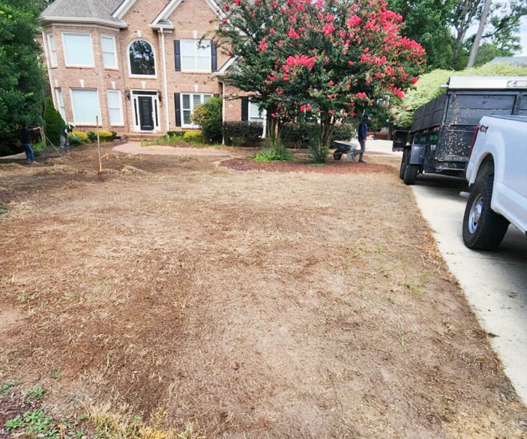 A large lot in the process of grading, showing extensive earth movement and leveling to prepare the site for future development.