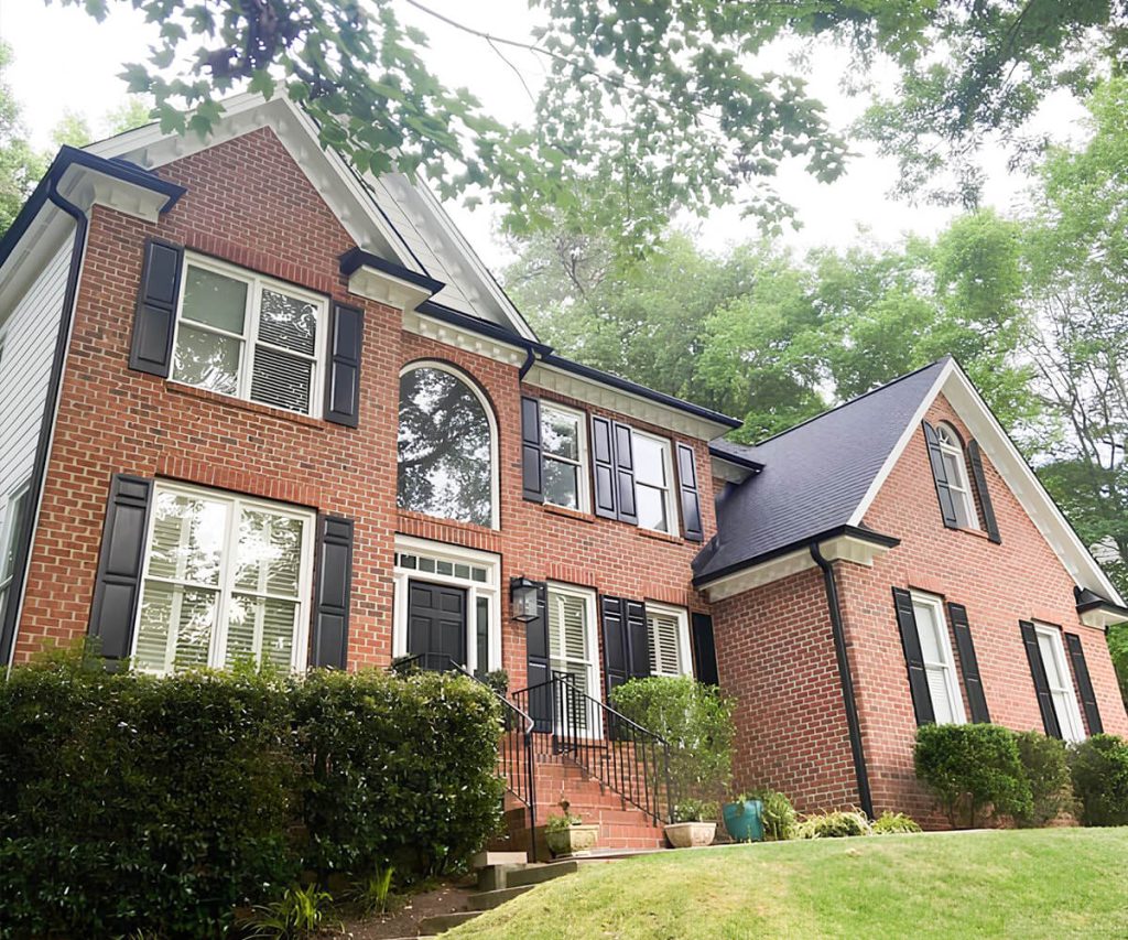 A large home featuring newly installed oversized gutters, designed to handle high volumes of rainwater effectively.