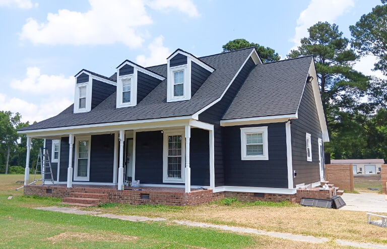 Completed home exterior painting project showing a beautifully refreshed and newly painted facade, with vibrant colors and a clean finish.