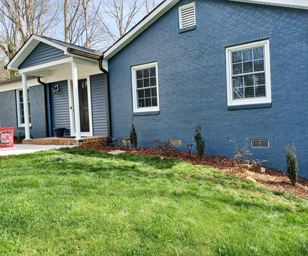 A home’s exterior with a newly completed paint job, showing a crisp, clean look and vibrant color that enhances its overall appearance.