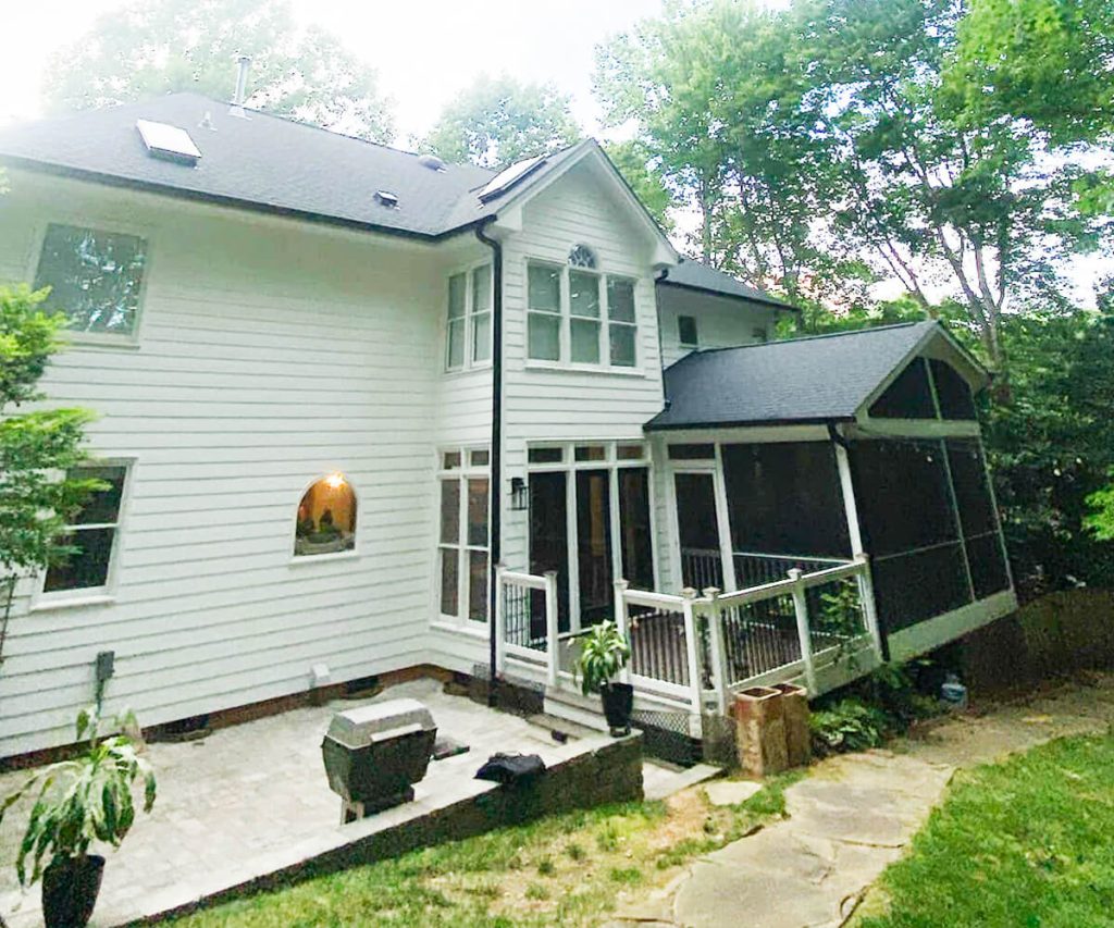 Large gutters installed on a big house, designed to handle high volumes of rainwater efficiently with a robust and seamless look.