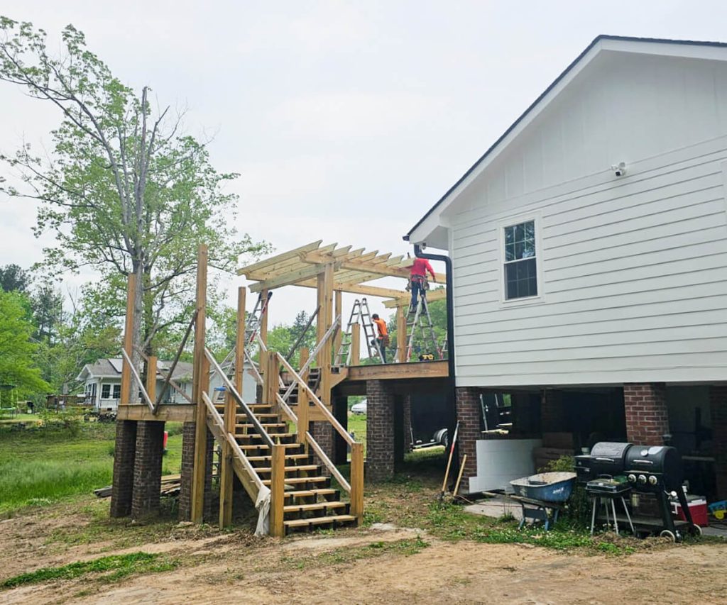 A beautifully designed outdoor space showcasing a new deck, pergola, and patio, creating an inviting and functional area for relaxation and entertainment.