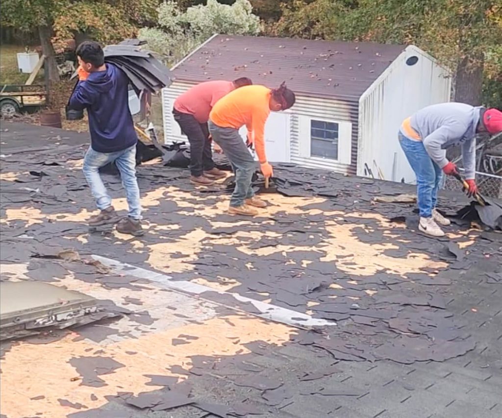 A team of professionals removing an old roof with attention to detail, showcasing high-quality workmanship and careful handling.