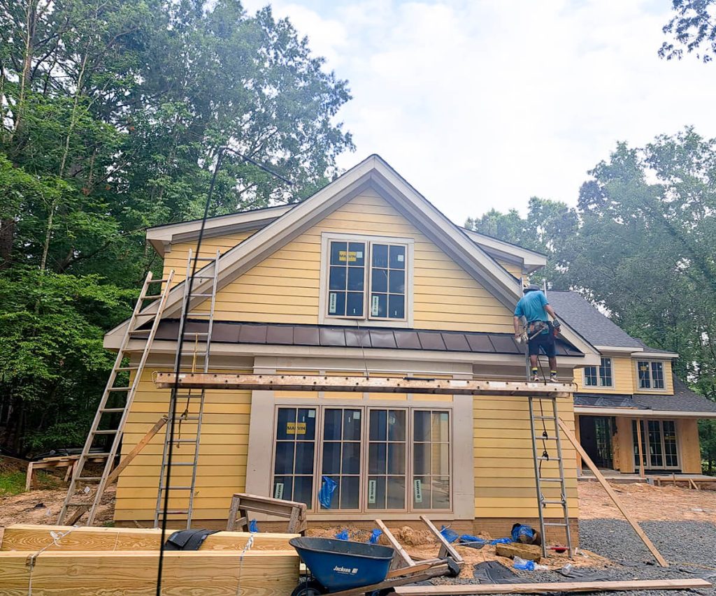 A home with siding installation nearly finished, showing the updated exterior with most of the siding panels in place.